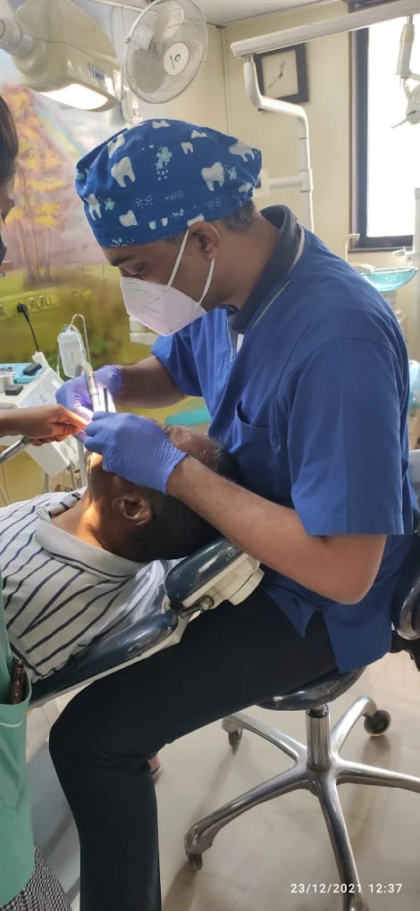Dr. Swapnil B. Patil treating a patient in the operatory